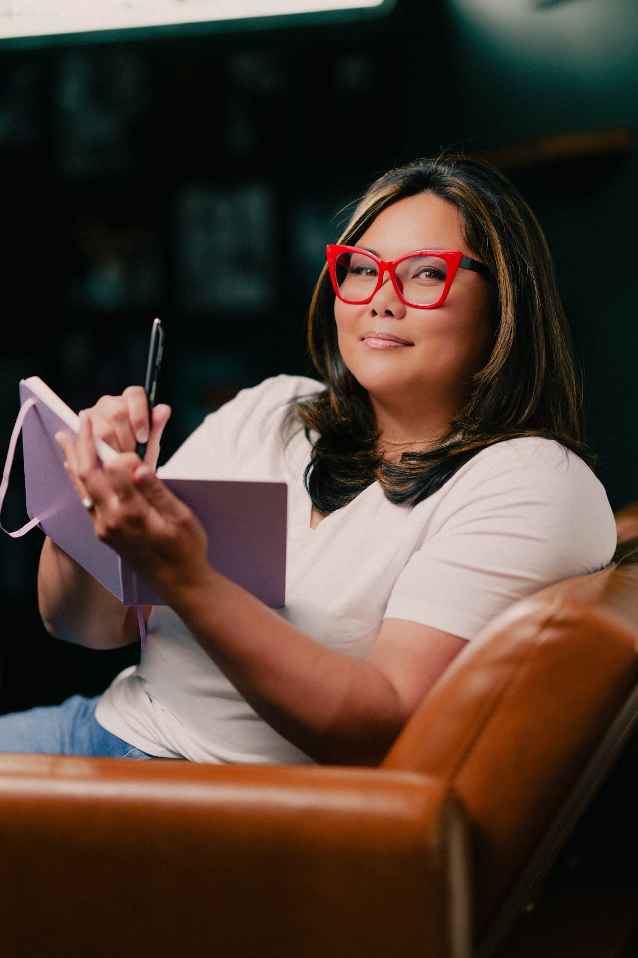 Kristine, founder of SPARK, taking notes in her notebook